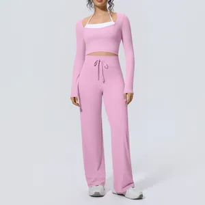 Front view of women's pink long-sleeve yoga set with high-waisted wide-leg pants