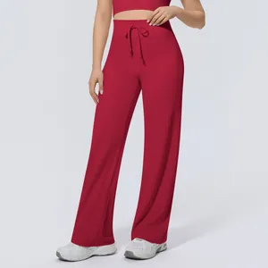 Detail view of high-waisted red wide-leg yoga pants with adjustable drawstring waist