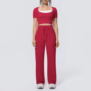 Front view of a red two-piece yoga set with crop top and wide-leg drawstring pants