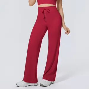 Close-up of wine red high-waisted wide-leg yoga pants featuring a front drawstring