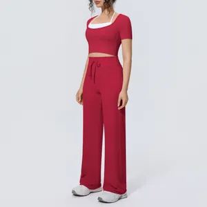 Red two-piece yoga set with short sleeve halter crop top and breathable wide-leg pants