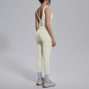 Side detail of cream V-neck sports bra and high-waisted yoga leggings for fitness.