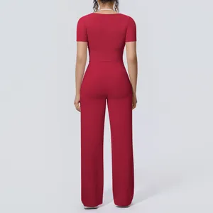 Back view of a red two-piece yoga set featuring a short sleeve top and wide-leg pants