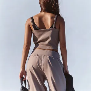 Back view of brown yoga sports set with thin strap backless camisole and wide-leg pants