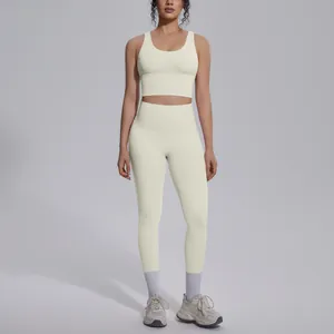 Front view of women's cream yellow yoga set with high waist leggings and sports bra