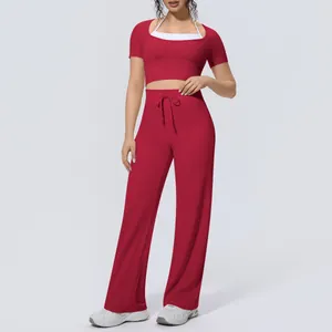 Red two-piece yoga set featuring a short sleeve crop top and wide-leg drawstring pants