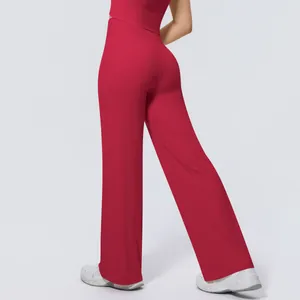 Detail view of high-waisted red wide-leg yoga pants featuring smooth athletic fabric