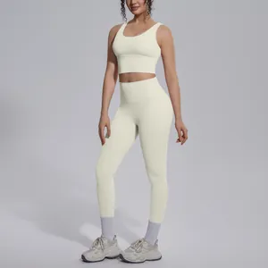 Close-up of cream white V-neck sports bra and high-waisted yoga leggings gym set