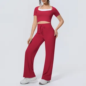 Red two-piece workout set with halter crop top and wide-leg yoga pants on model view