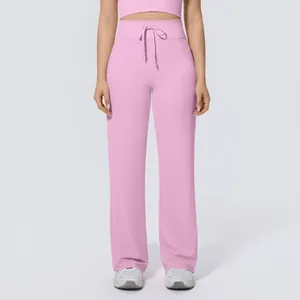 Detail showing high-waisted drawstring design on pink wide-leg yoga pants for workout.
