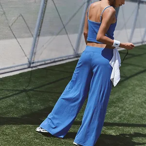Detailed view of a blue wide-leg yoga pant and strappy backless tank top sports set.