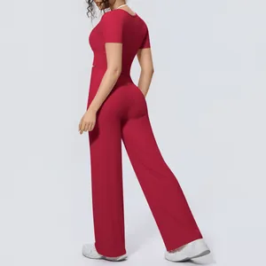 Back view of a breathable red two-piece yoga set featuring short sleeves and wide-leg pants