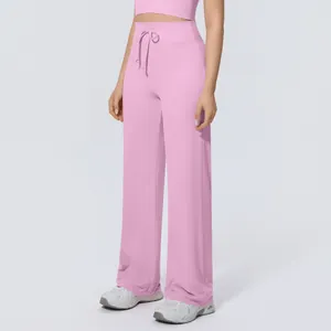 Pink high-waisted wide-leg yoga pants with drawstring detail.