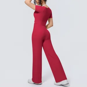 Back view of a red two-piece yoga set with short sleeve top and wide-leg pants for women
