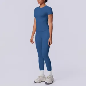 Seitenansicht einer Frau im blauen nahtlosen Kurzarm-Yoga-Set mit Top und Leggings