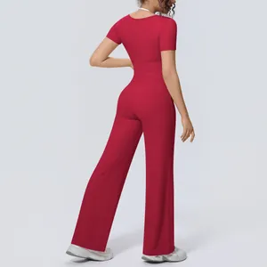 Back view of a red two-piece yoga set featuring a short-sleeved top and wide-leg pants.