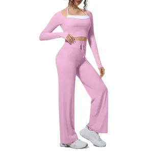 Stylish women pink long sleeve yoga set featuring a crop top and wide leg fitness pants