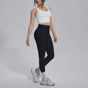 Close-up view of the high-waist black leggings and white V-neck sports bra set