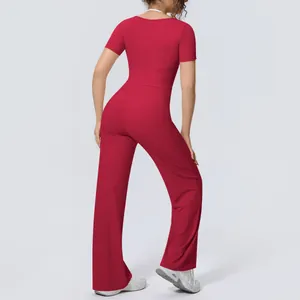 Back view of a red short-sleeved yoga top and matching high-waisted wide-leg sports pants.