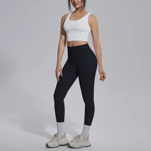 Detail of women's yoga set with V-neck sports bra and high-waist black leggings.