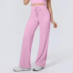 Detail of pink high-waisted yoga pants with drawstring and wide-leg fit