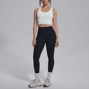 Full body view of a white sports bra and black naked-feel yoga leggings set for women