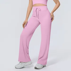 Detail showing high-waisted pink wide-leg sports pants with functional drawstring