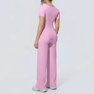 Back view of pink yoga set with short sleeve top and wide leg pants for women.