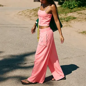 Detailed shot of pink yoga set with camisole and wide-leg pants in an outdoor setting