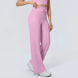 Detail view of pink high-waist drawstring wide-leg sports pants for fitness.