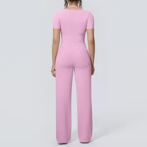 Back view of a pink short-sleeve yoga set with high-waist wide-leg pants for women