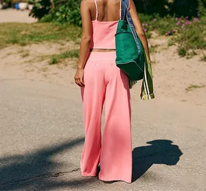 Back view of a pink yoga set with thin straps camisole and wide-leg sports pants.