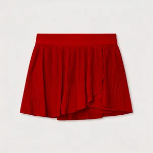 Detail view of a vibrant red pleated tennis skort with quick-dry fabric and asymmetric hem
