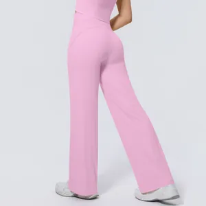 Back view of pink high-waist wide-leg yoga pants showing smooth fabric and slim fit.