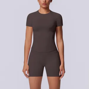 Vooraanzicht van een donkerbruine naadloos gebreide yogaset op een vrouwelijk model