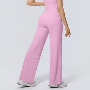 Back view of pink high-waisted wide-leg yoga pants showing a loose and draped fitness fit