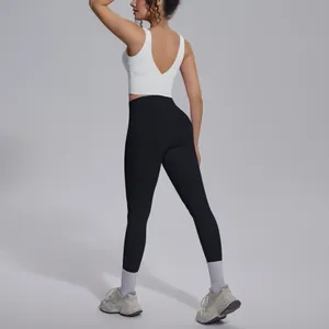 Back view of white V-neck sports bra and black leggings yoga set with athletic fit.