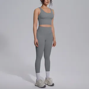 Grey two-piece yoga set with V-neck sports bra and high-waist leggings on model