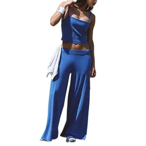 Blue two-piece yoga set with thin strap crop top and relaxed wide-leg fitness pants.