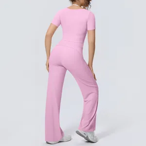 Detailed back view of a pink yoga set with short-sleeve top and breathable wide-leg pants