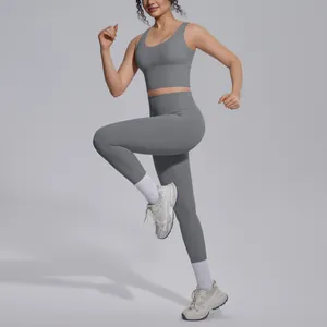 Detailed studio view of professional grey high-waisted yoga set with sports bra and leggings.