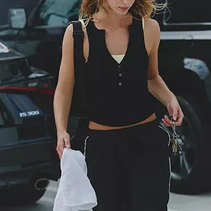 Close-up of a slim fit black henley button tank top for women's yoga and pilates