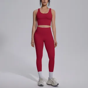 Detail view of a women's dark red seamless yoga set featuring leggings and sports bra