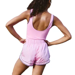 Pink two-piece workout set with contrast trim tank top and high waisted shorts