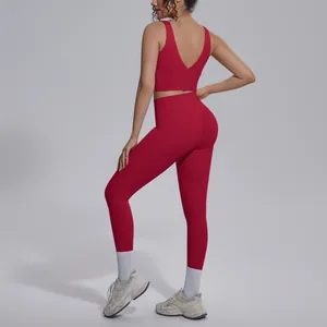Back view of a red two-piece yoga set featuring a V-neck sports bra and seamless leggings
