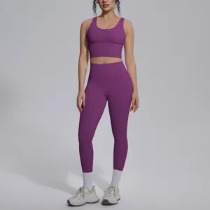 Two-piece purple yoga set featuring a V-neck sports bra and high-waist seamless leggings.