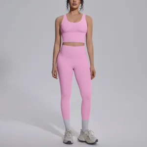 Detailed view of a pink high-waist yoga set including a V-neck sports bra and leggings