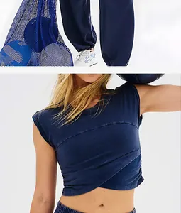 Close-up detail of navy blue sleeveless crop top and matching sweatpants sports set