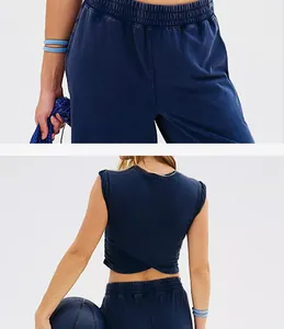 Close-up detail of navy sleeveless crop top with wrap back and elastic waist sweatpants.