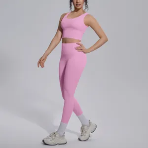 Female model wearing a pink two-piece yoga set with V-neck sports bra and leggings